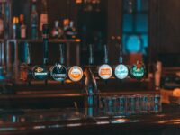 a row of beer taps sitting on top of a bar