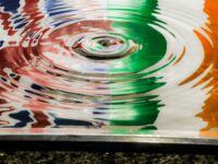 a multicolored bowl with water ripples into it